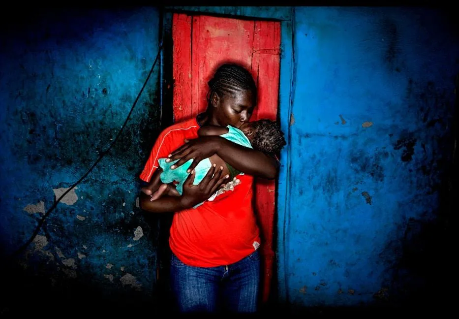 The Pink Door Photographs by Rodney Rascona printed by theprintspace woman kissing a child