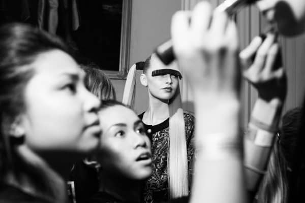 Asia Werbel images from backstage at London Fashion Week printed on Fuji Crystal Archive Matt photographic printing paper model being prepped by make up and styling for the show