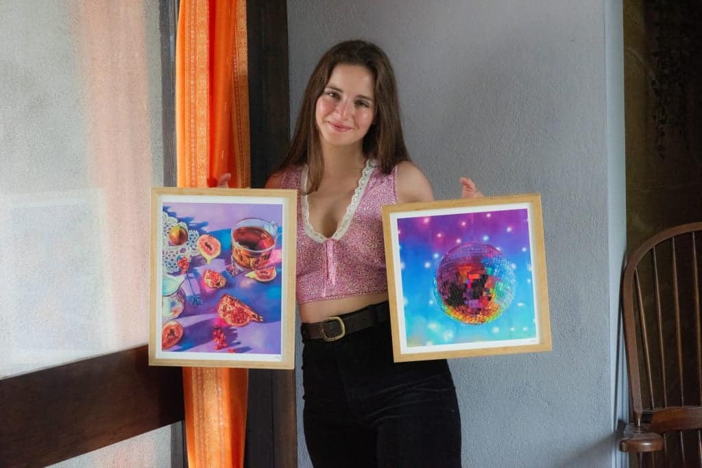 Artist displaying her art prints, illustrating how to price your art for sale online.